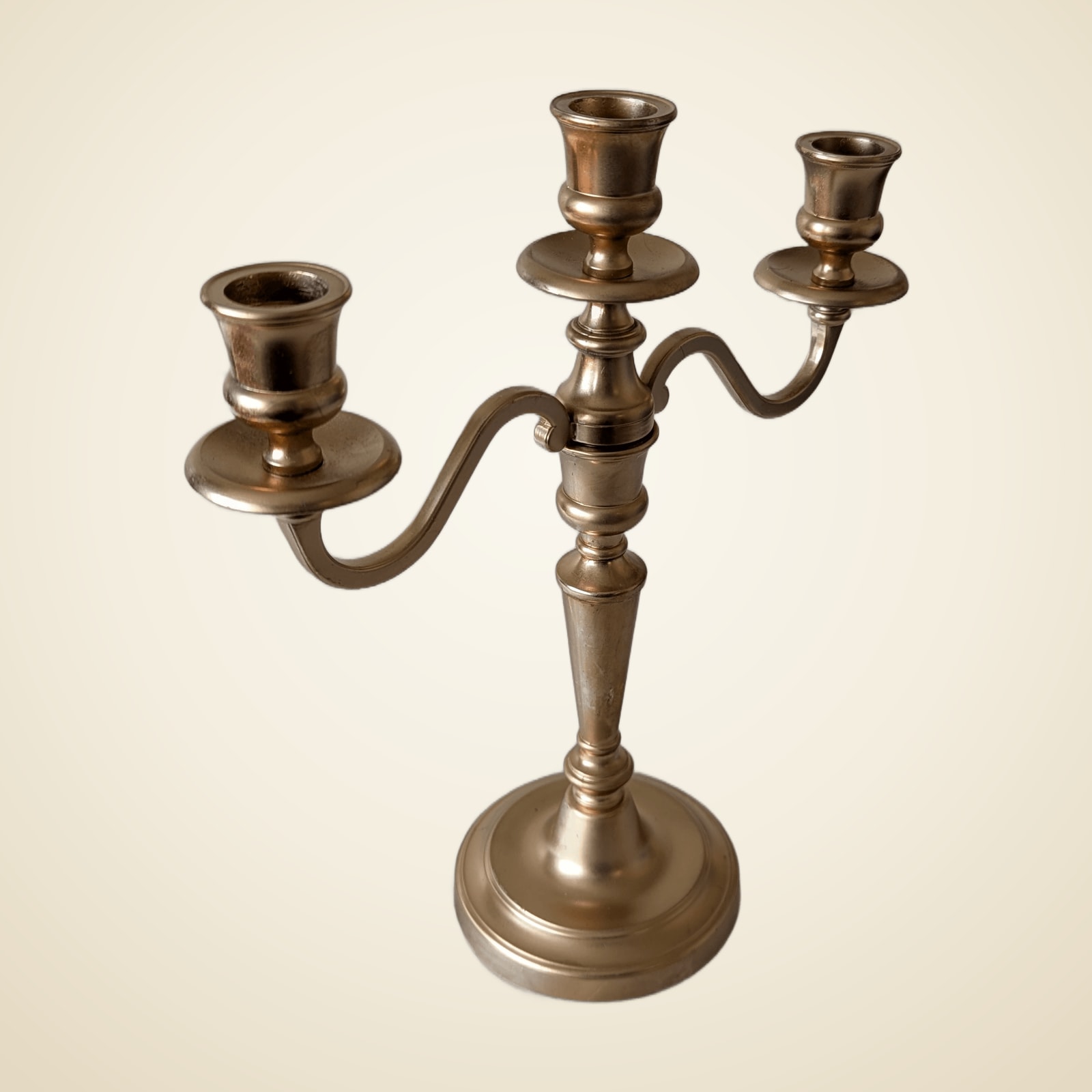 Antique gold triple candlestick holder.